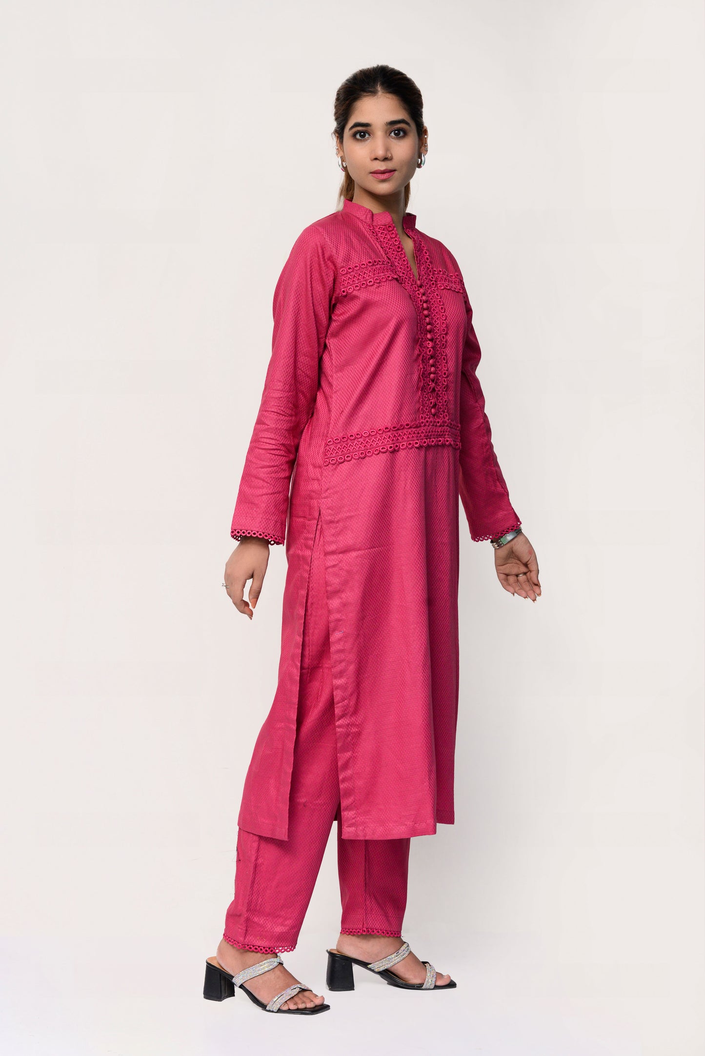 Woman wearing a pink traditional outfit with a white background