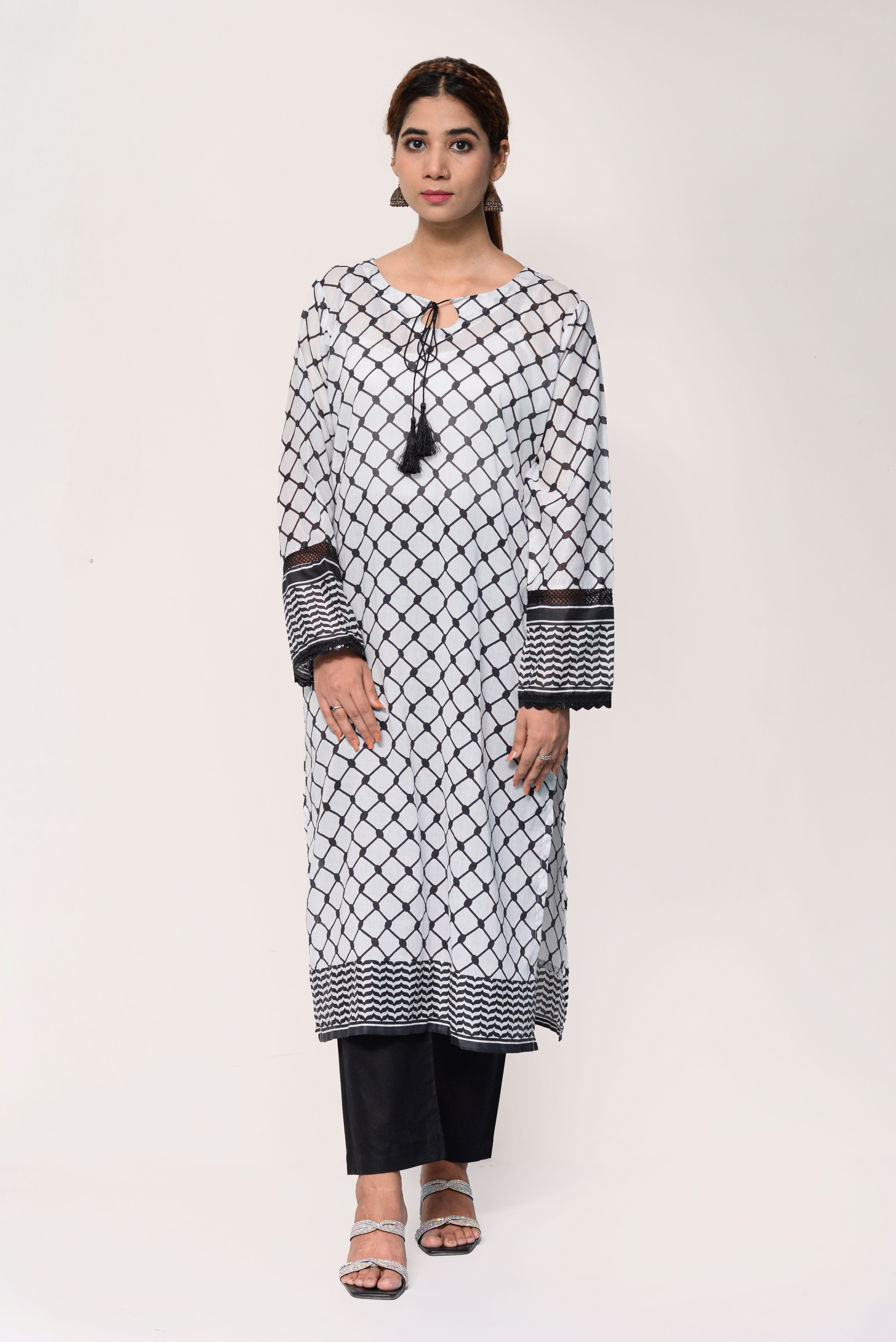 Woman wearing a black and white Keffiyah patterned kurta with black pants on a white background