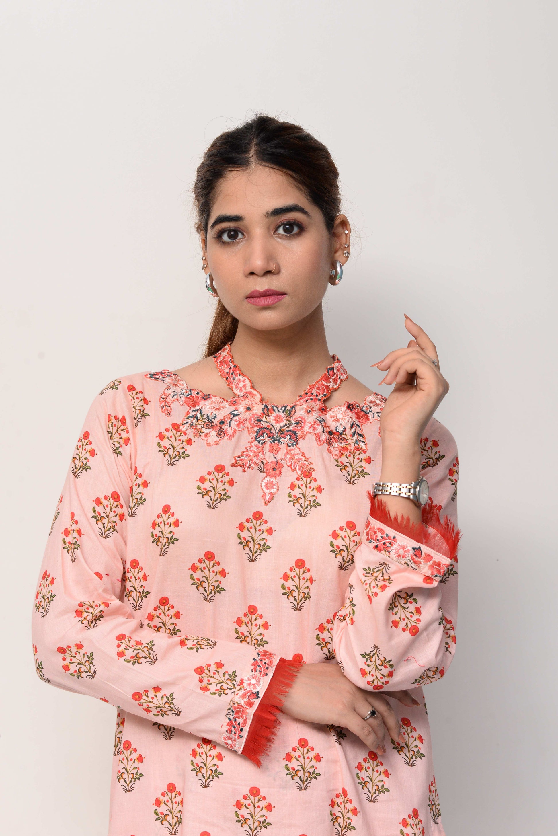 Woman wearing a pink floral dress on a white background