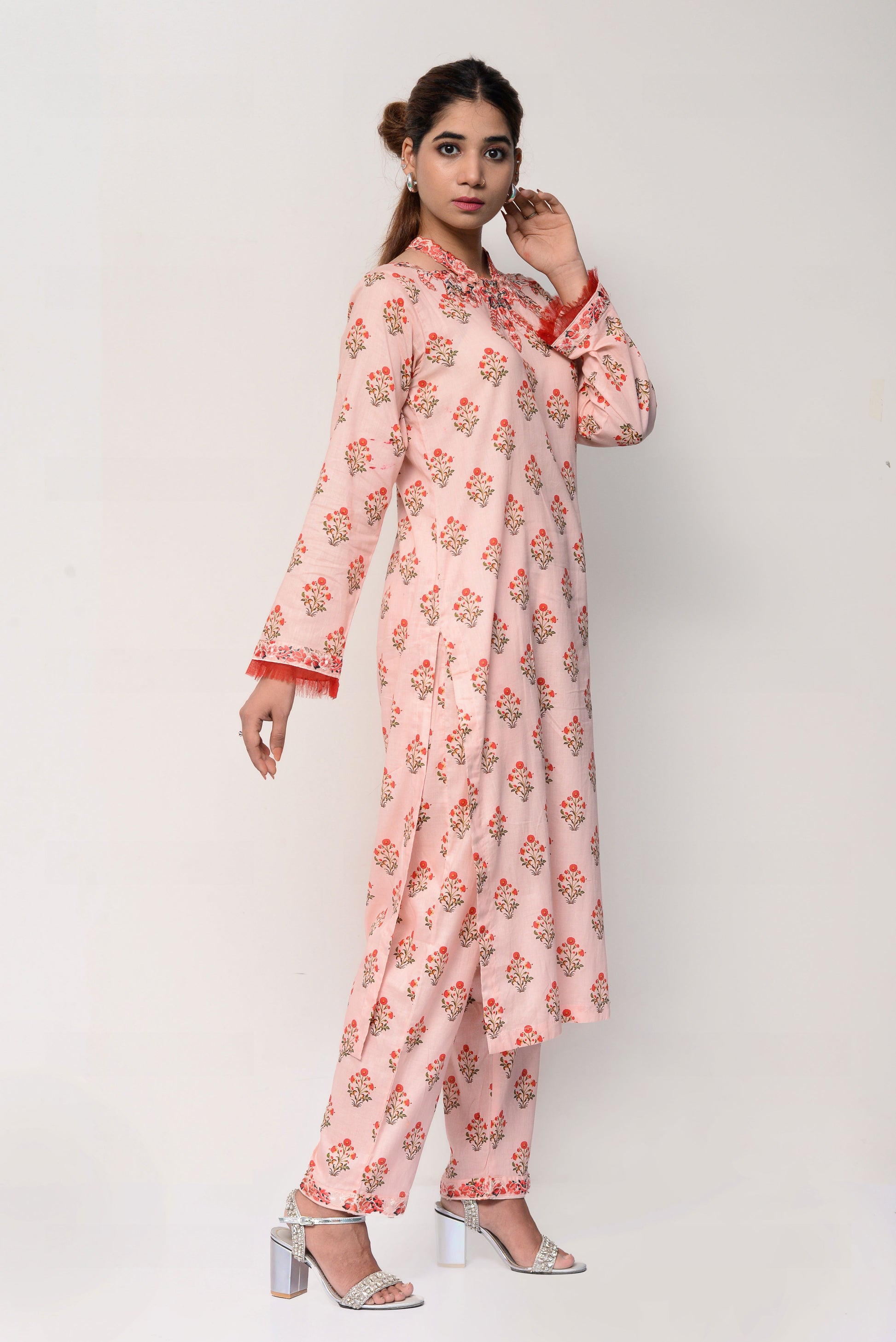 Woman wearing a pink floral dress on a white background