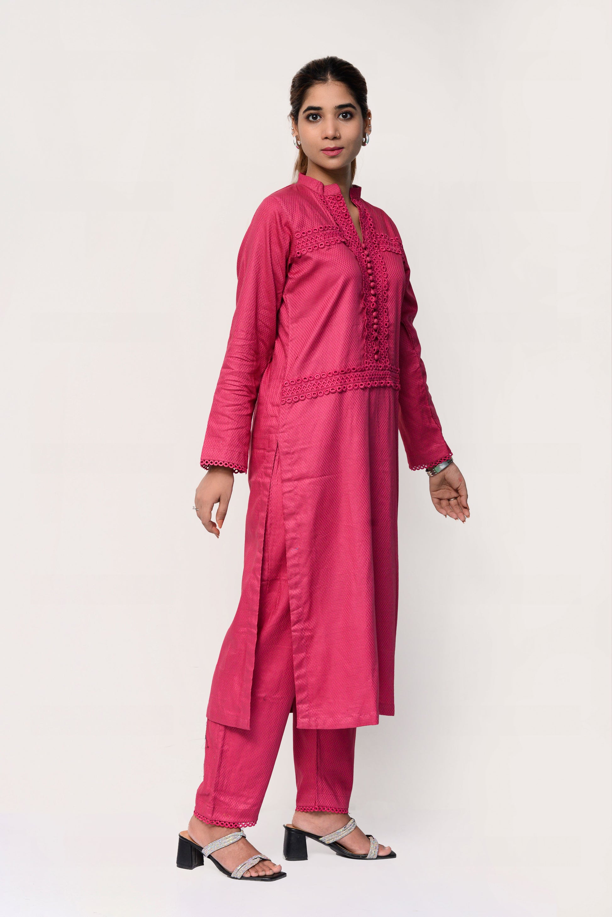 Woman wearing a pink traditional outfit with a white background