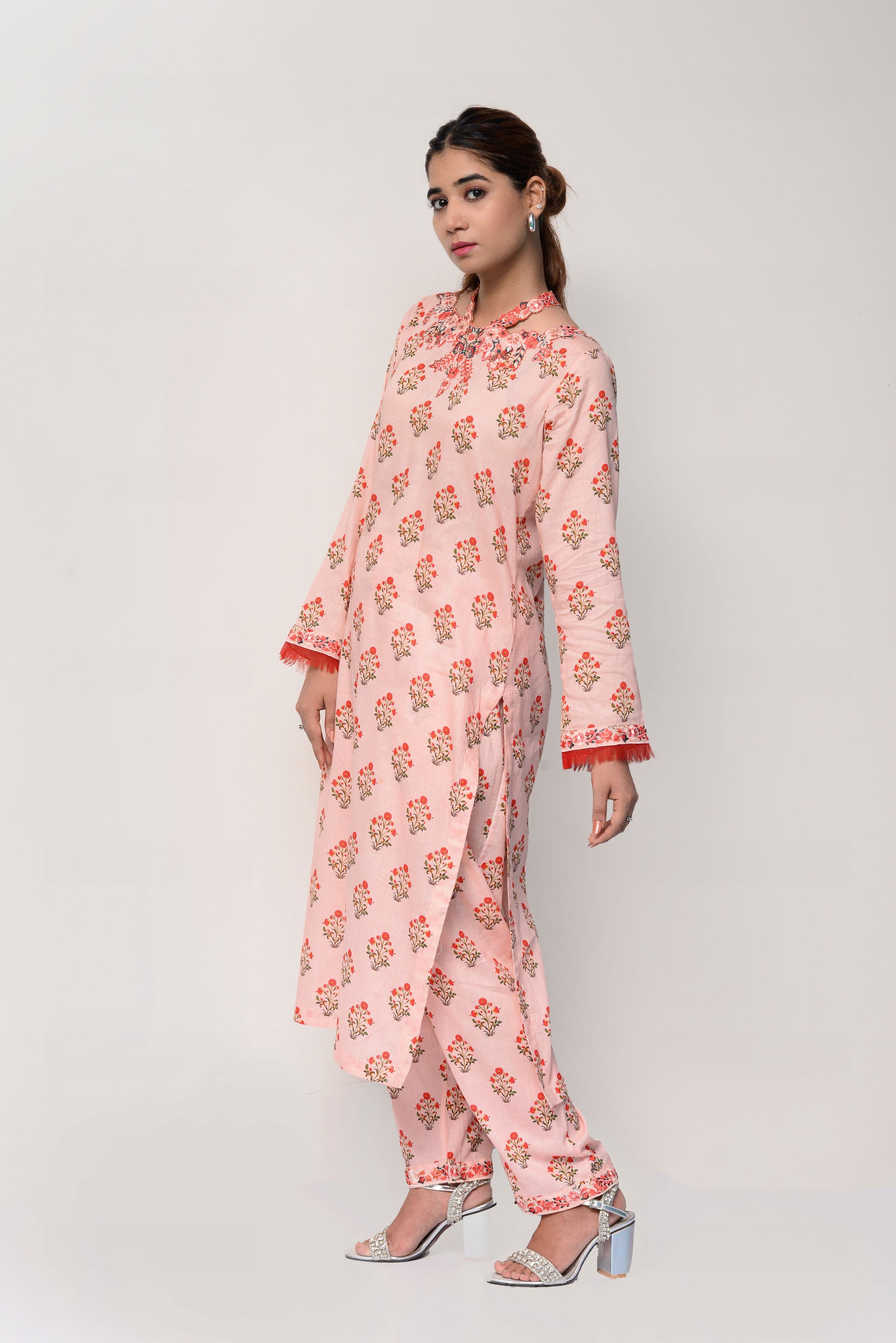 Woman wearing a pink floral dress on a white background