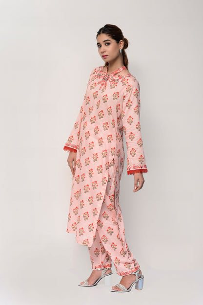 Woman wearing a pink floral dress on a white background